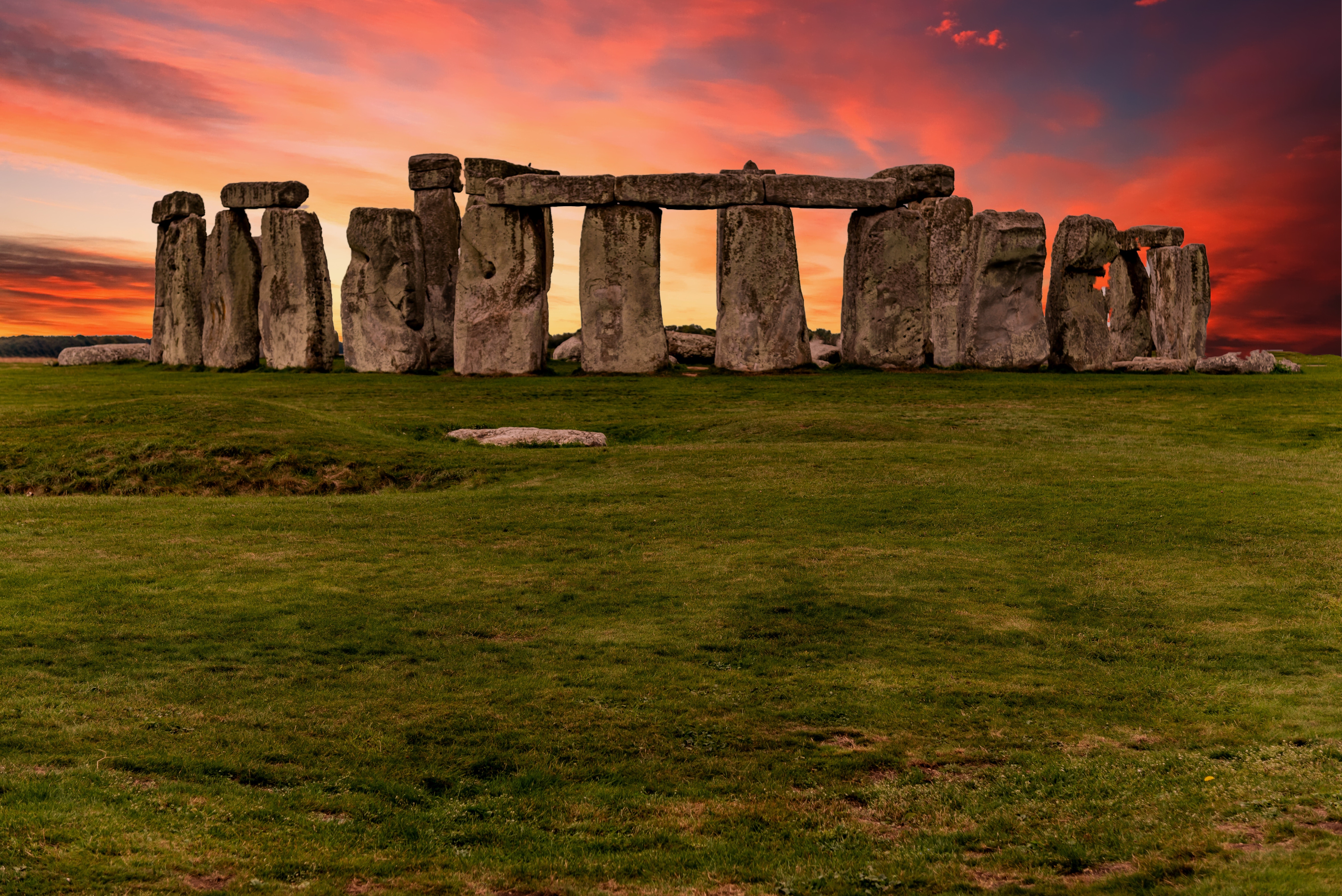 small picture of stonehenge with a pinkish sunset